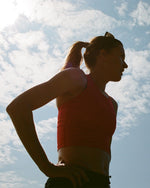 Woman seen standing in the shadow of the sun. 