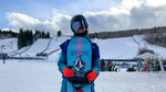 Loranne Smans wearing a blue jacket while posing with her snowboard.