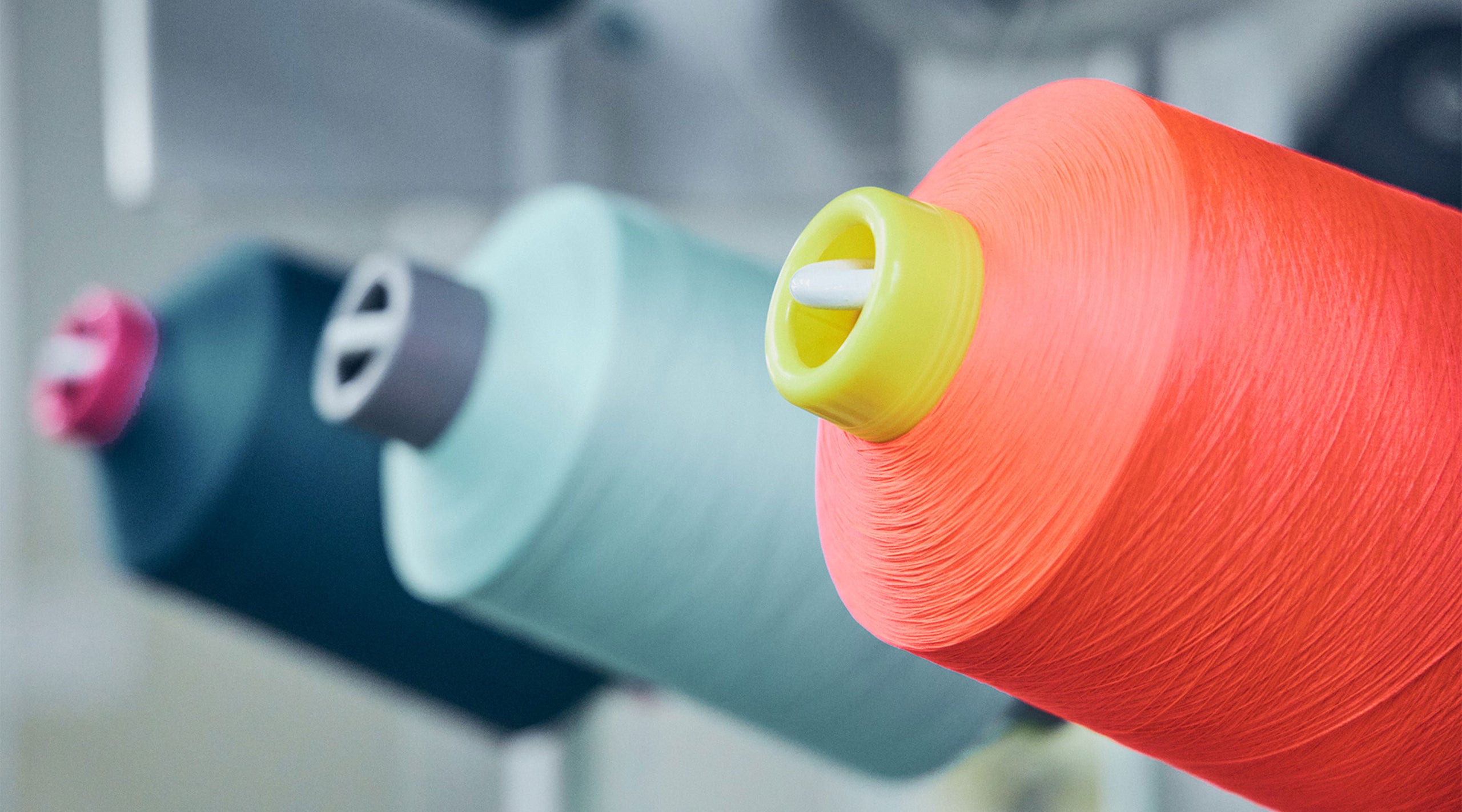 Bundles of colorful threads next to each other.